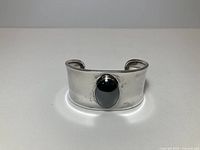 Front view showing cuff face and black cabochon