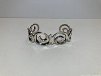 Front view of sterling silver scroll cuff bracelet