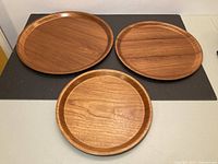 All three teak trays displayed nested