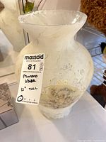 Vase front with tag showing height