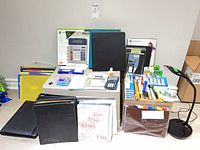 Full lot displaying lamp, calculators, binders, folders, paper, writing supplies