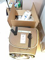 Closed rolling picnic bag and cardboard box of disposables