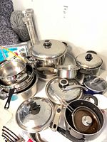 Stacked stainless pots, pans and lids