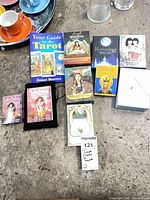 Overall lot view showing book, nine boxed decks, and pouch