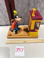 Full view of Goofy figure on lane with cabinet and ruler for scale