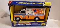 Front view of boxed Buddy L motorized ambulance showing graphics and toy inside