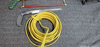 Overview showing hacksaw, hand saw and coiled wire