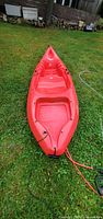 Top view of red 9 ft Emotion Charger kayak showing interior and bow
