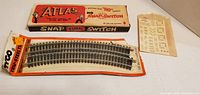 Atlas Snap Switch box, Tyco curved track in package, decal sheet
