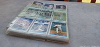 Stack of plastic binder pages holding baseball cards, side view