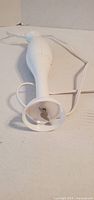 Full view of white hand blender showing blade guard and cord