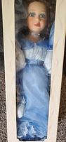 Front view of boxed 24" porcelain doll