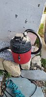 Full view of Craftsman red canister shop vac with hose and cord