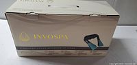 Front of unopened InvoSpa retail box showing product image
