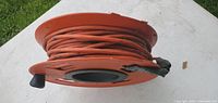 Cord wound on orange reel, side view