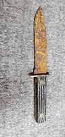 Full view of knife showing rusted blade and handle