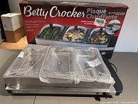 Buffet warmer with box and bubble-wrapped pans visible