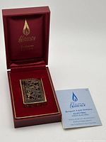 Lighter in open red presentation box with instruction manual visible