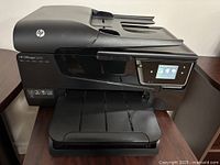 Front view of HP Officejet 6600 printer with tray extended