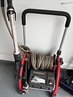 Full view of HydroSurge pressure washer with hose reel and wand