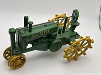 Left side view of spoked-wheel cast iron tractor
