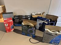 All ten boxes of NOMA and Home Accents blue LED lights on table