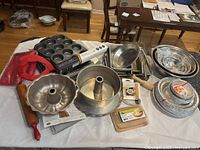 Full lot overview on table showing pans, bowls, utensils