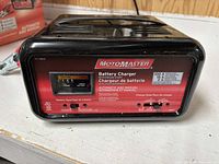 Front view of battery charger showing MotoMaster branding and control panel
