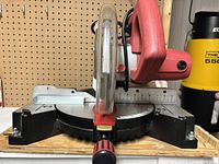 Front view of sliding compound miter saw showing blade guard, base, and miter scale