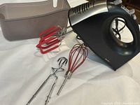 Mixer with beaters, whisk, dough hooks and storage case displayed