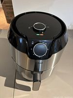Front view of T-fal stainless steel air fryer with dial