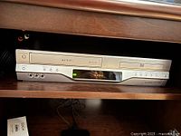 Front view of Toshiba SD-V30 combo unit in shelf