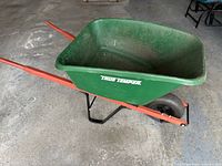 Full side view of green True Temper wheelbarrow