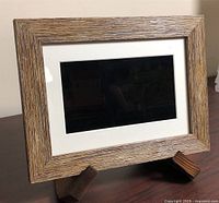 Front view of Aluratek 7" photo frame on tabletop