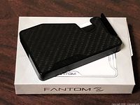 Front view of money clip on Fantom box