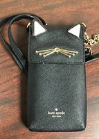 Front view showing cat ear flap, whisker hardware and logo