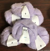 Six lilac balls of Hobbii Diablo yarn with labels