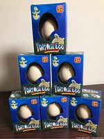 Six boxed Tortoise Egg toys stacked