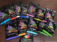 Front view of twelve assorted Chameleon Color Powder packets