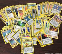 Spread of assorted Pokémon cards showing creatures, Trainer and Energy types