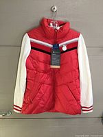Front view of red and cream LPGA women’s jacket showing tag, chest stripe and crest