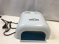 Front angled view of NuLink UV lamp showing overall form and power cord