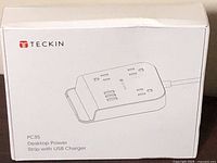 Retail box front showing Teckin branding and line art of power strip