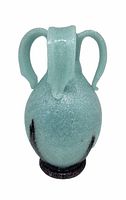 Full frontal view of sea foam green glass vase, showing handles and textured surface