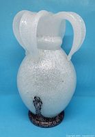 Front view showing full form, three handles and spongy texture