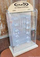 full view of clear acrylic and wood Wiley X display case