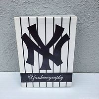 Front of Yankeeography slipcase showing interlocking NY logo
