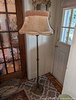 Full view of lamp beside door showing height and overall design