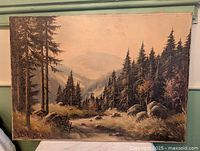 Full view of oil painting showing mountain forest scene