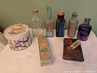 Group shot showing all bottles, tins, and boxed item